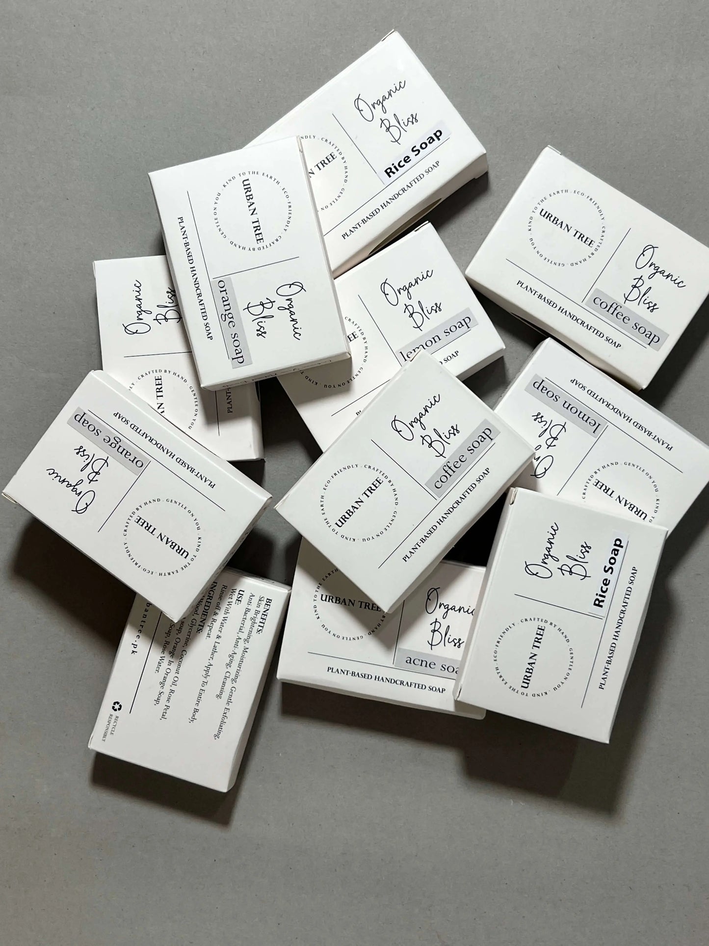 Urban Tree Organic Bliss handcrafted soap boxes stacked in a scattered layout