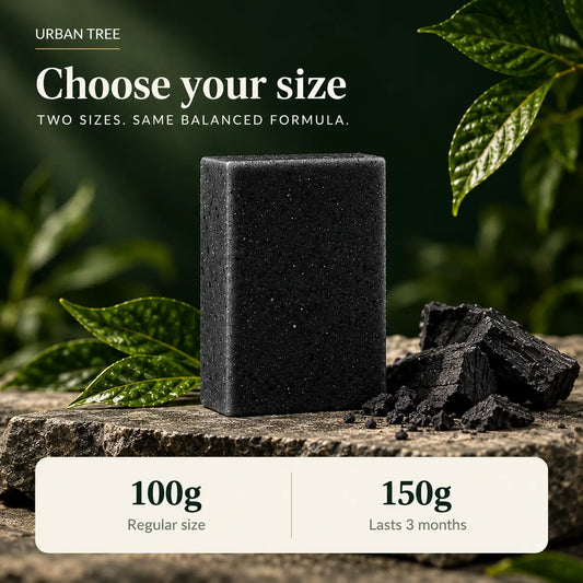 Black Charcoal Soap bar on a stone slab with charcoal pieces, available in 100g regular and 150g sizes