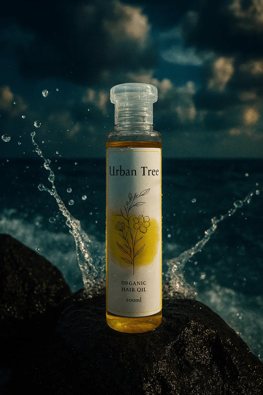 Organic Hair Oil by Urban Tree – pure botanical blend captured with ocean splash symbolizing strength, shine, and scalp health.