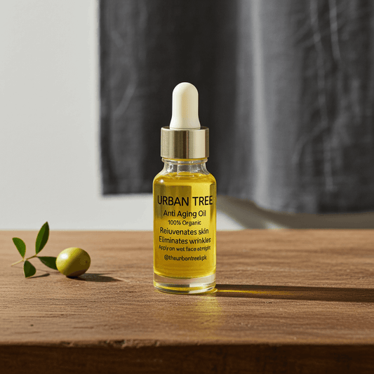 Urban Tree Anti-Aging Oil organic serum bottle on wooden surface with olive fruit – natural wrinkle care and rejuvenating face oil in Pakistan