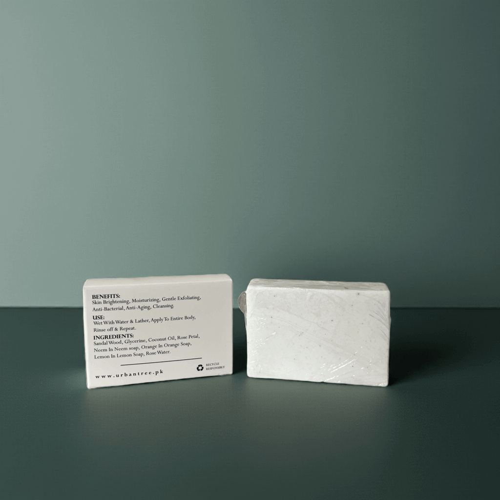 Urban Tree Rice Radiance Soap, skin brightening and moisturizing organic soap with full ingredient list, handmade in Pakistan on a dark surface against a green background
