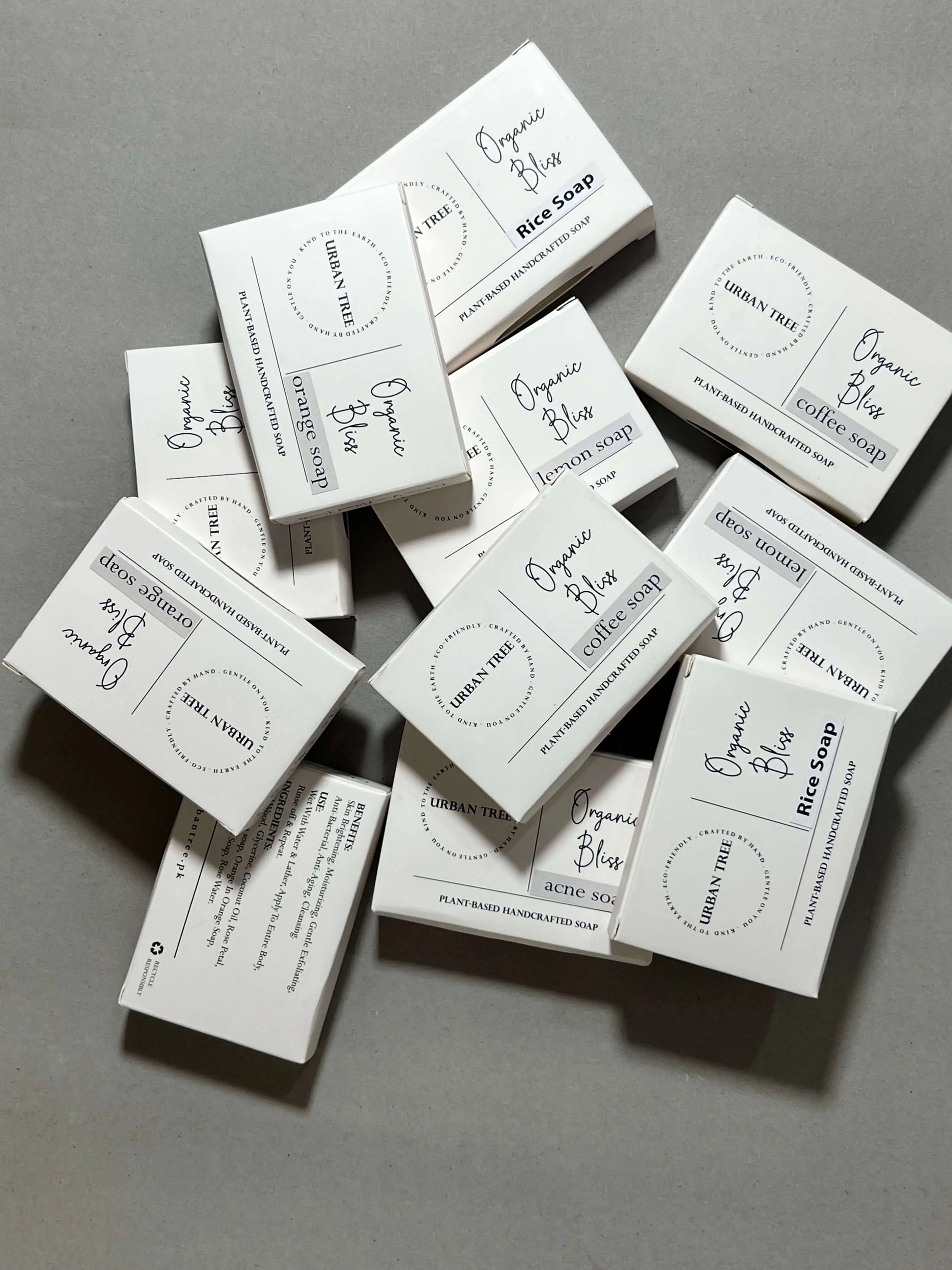 Urban Tree Organic Bliss handcrafted soap boxes stacked in a scattered layout