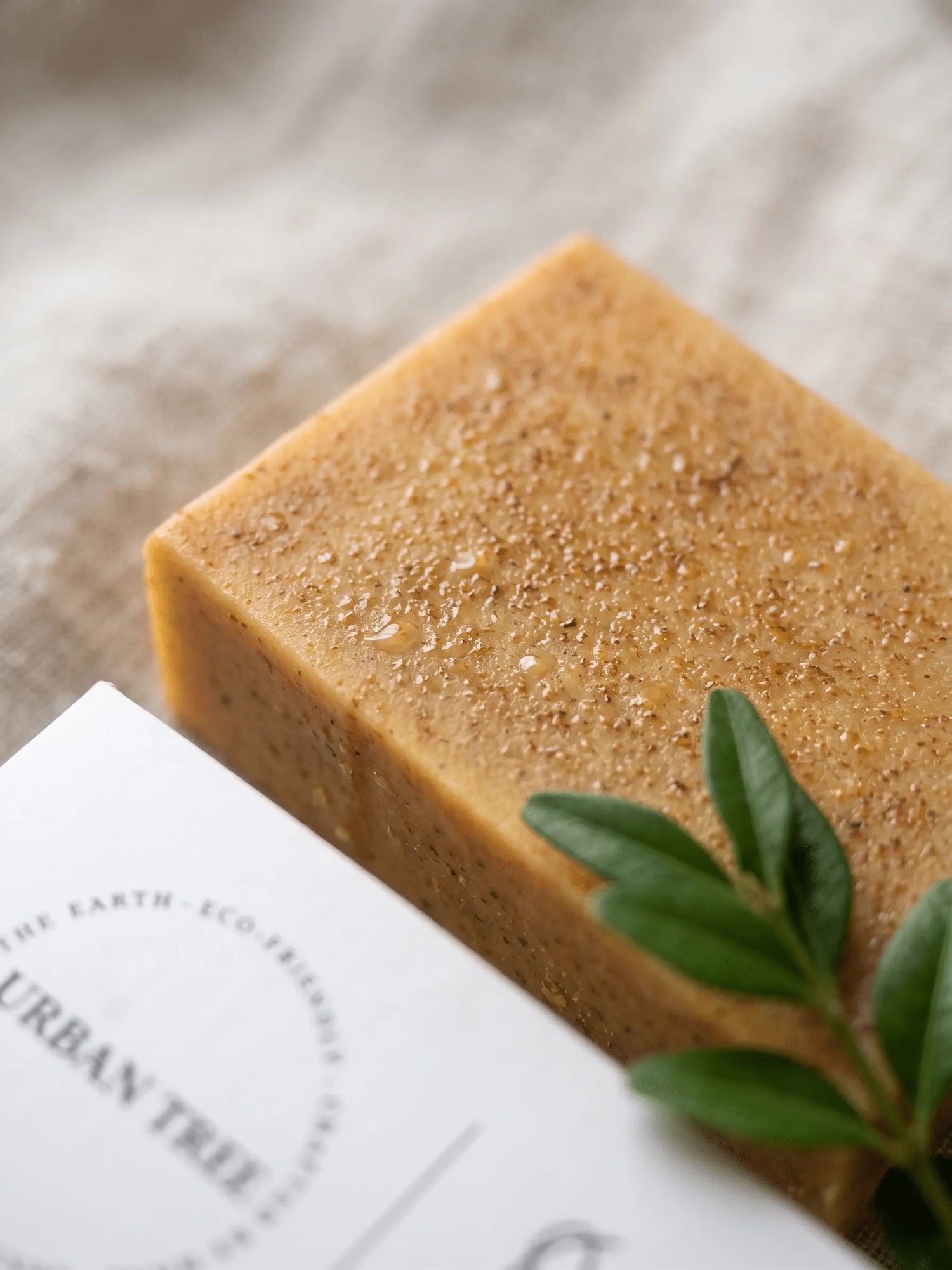 Close up of Urban Tree Turmeric Kojic Acid Soap showing natural texture and handcrafted formulation