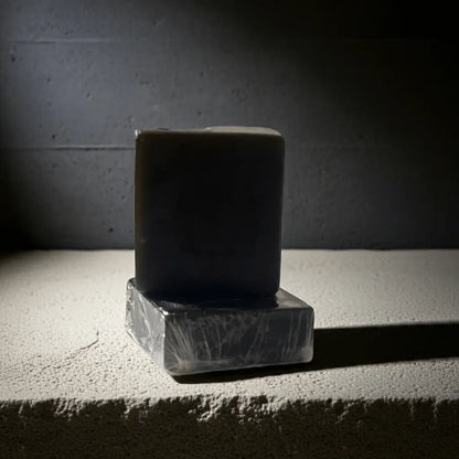 Urban Tree Charcoal Activated Soap wrapped bar displayed on stone block with shadow