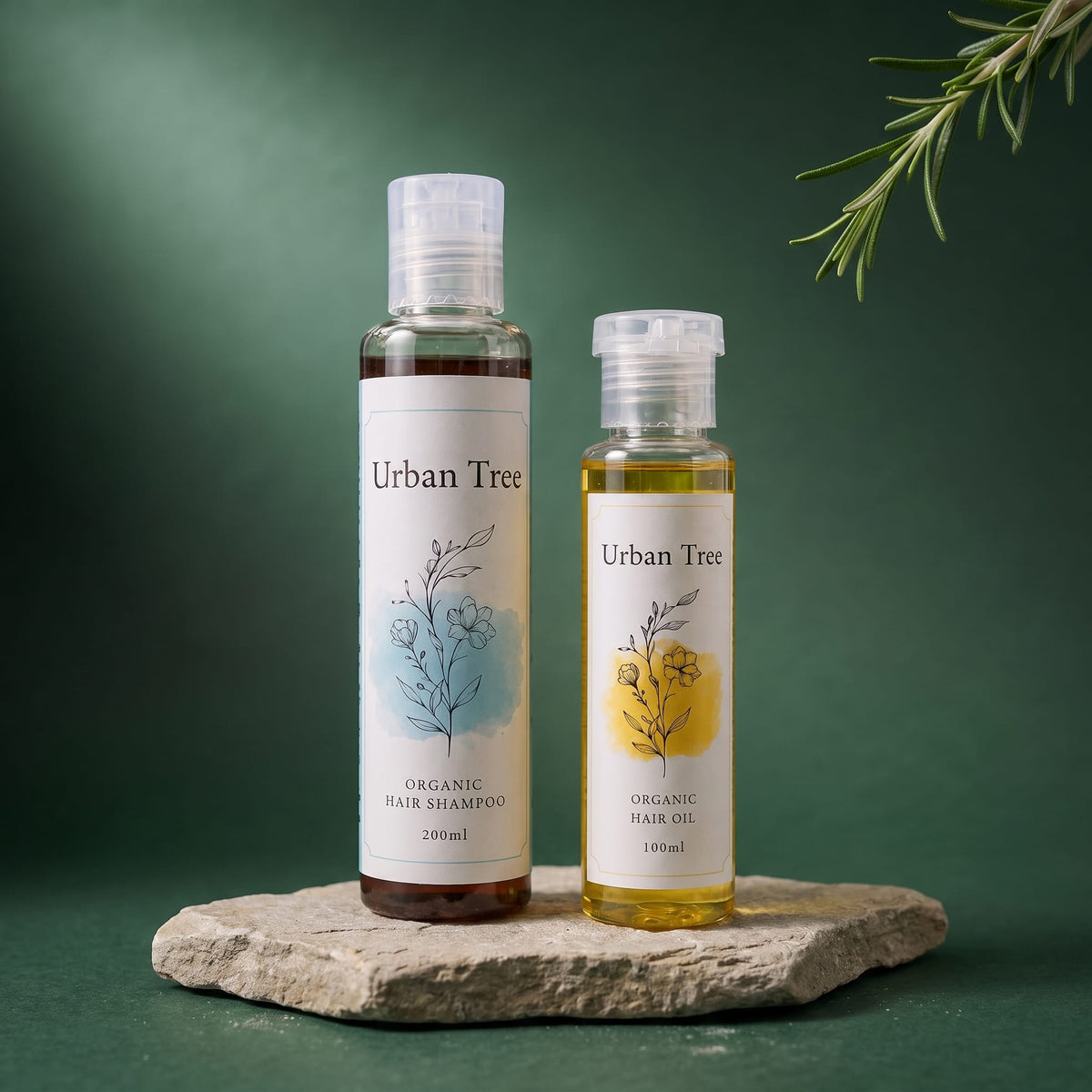 Urban Tree Hair Revival Duo with 200ml organic shampoo and 100ml hair oil bottles together on a stone slab