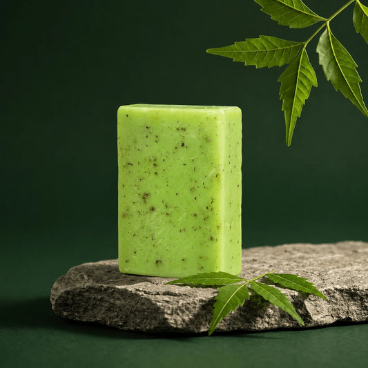 Urban Tree Neem and Tea Tree Soap, green herbal bar speckled with neem, on a stone slab with fresh neem leaves