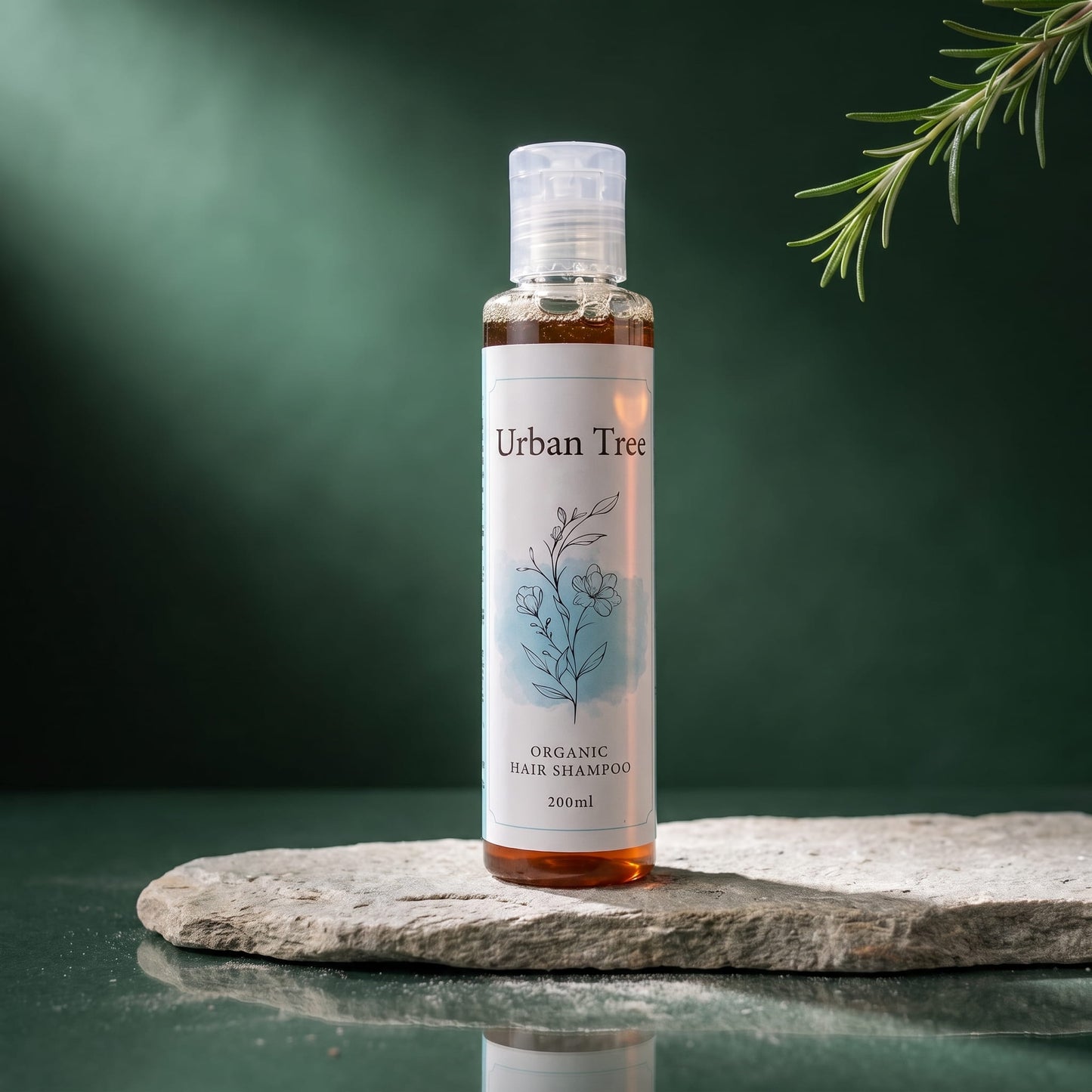 Urban Tree Organic Sulfate-Free Shampoo 200ml bottle on a stone slab with a rosemary sprig against a deep green background