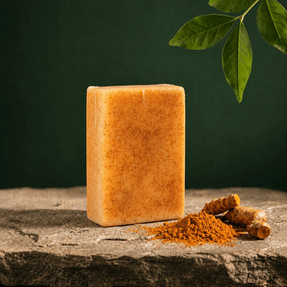Urban Tree turmeric kojic acid soap bar with turmeric roots on a dark green background
